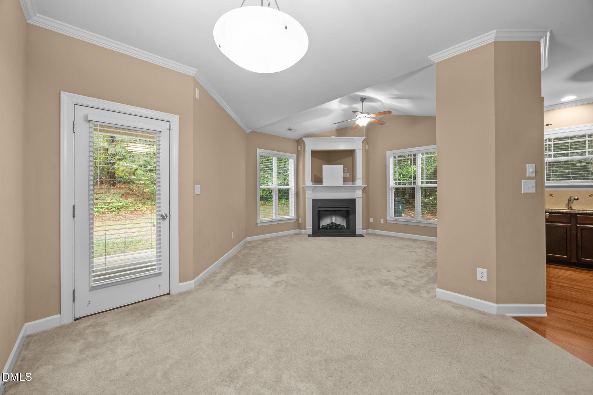 1929 Fieldhouse Avenue Raleigh, NC 27603 - Photo 11 of 29 an empty room with windows fireplace and fan