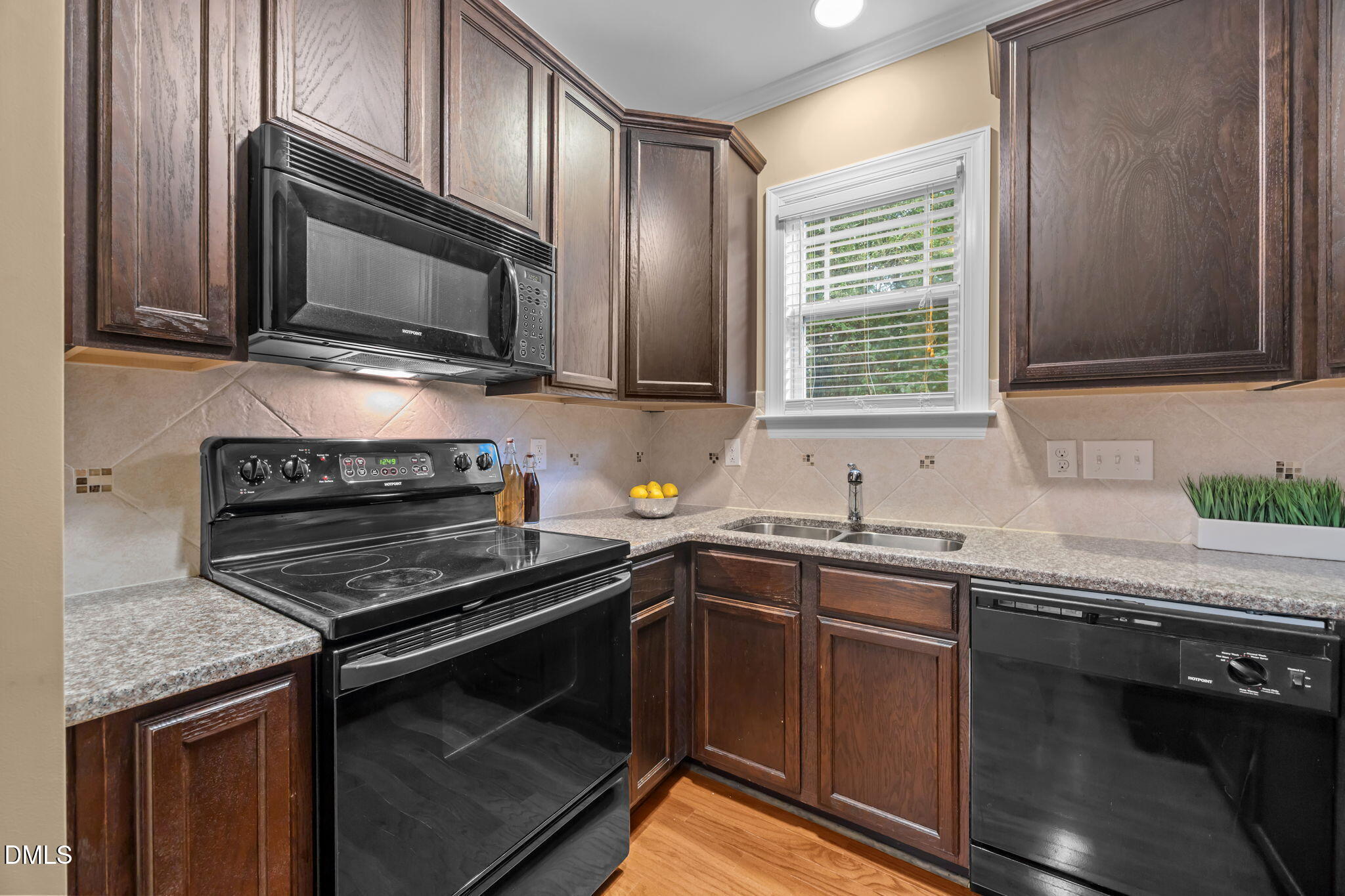 1929 Fieldhouse Avenue Raleigh, NC 27603 - Photo 3 of 29 a kitchen with a sink stove and microwave