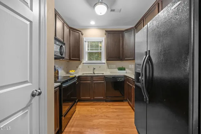 a kitchen with a sink stove and microwave