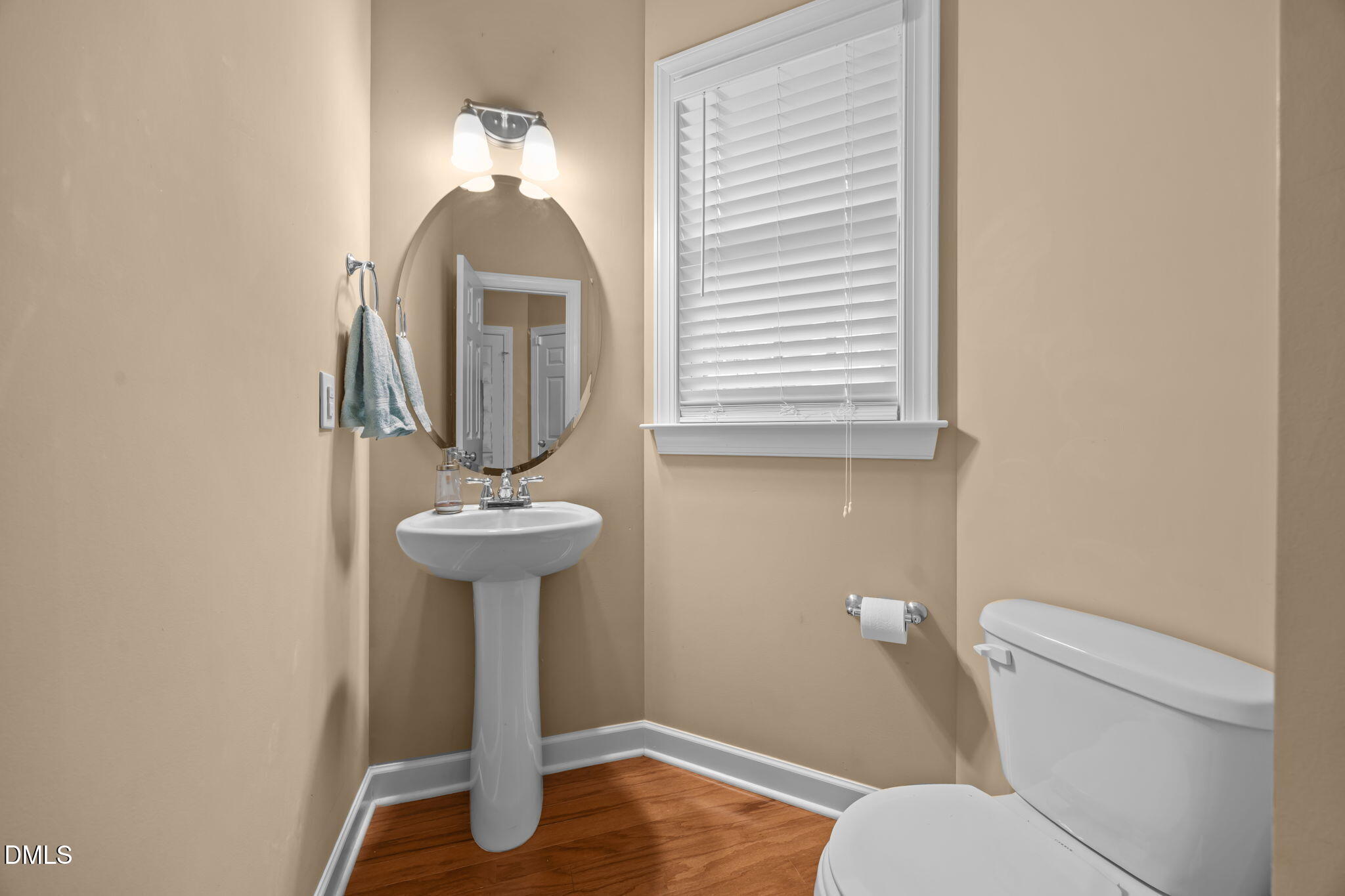 1929 Fieldhouse Avenue Raleigh, NC 27603 - Photo 7 of 29 a bathroom with a toilet sink and mirror