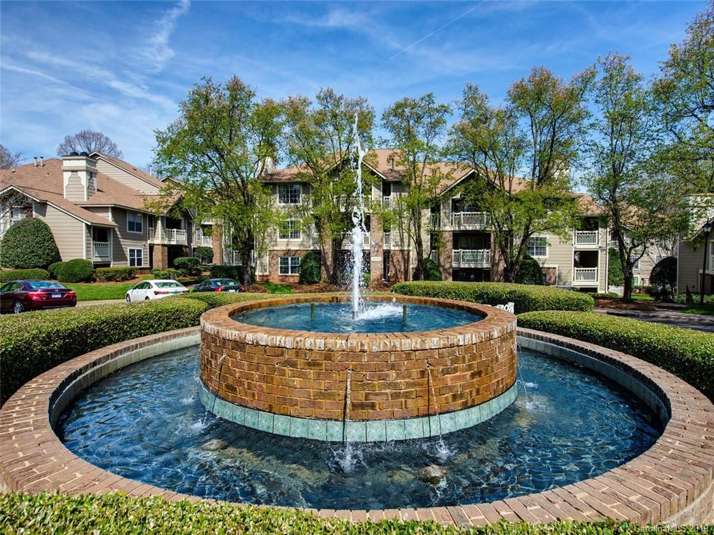 a view of a water fountain in front of a house