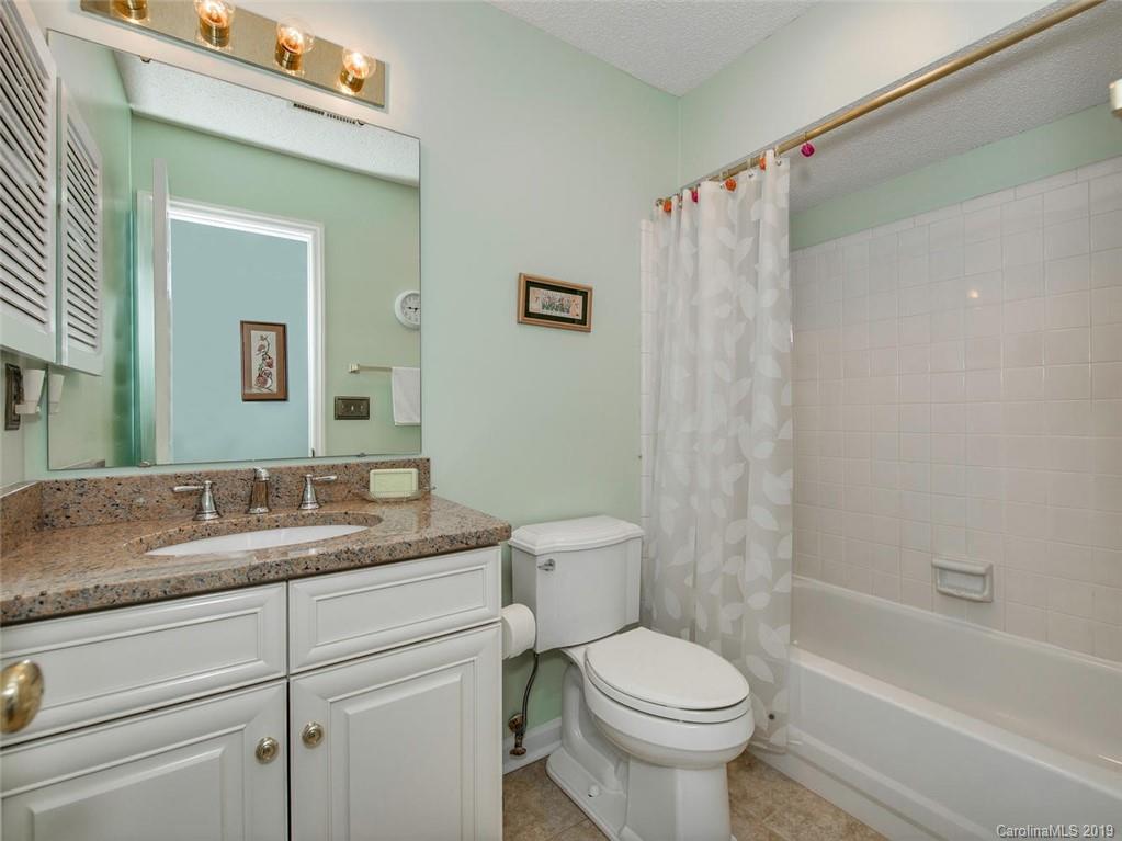 5009 Sharon Road Charlotte, NC 28210 - Photo 13 of 16 a bathroom with a granite countertop sink toilet and shower