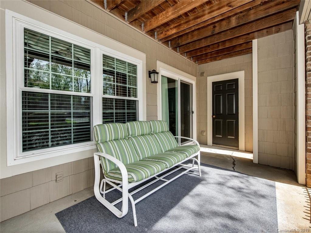 5009 Sharon Road Charlotte, NC 28210 - Photo 14 of 16 a view of a two chairs in the back yard of the house