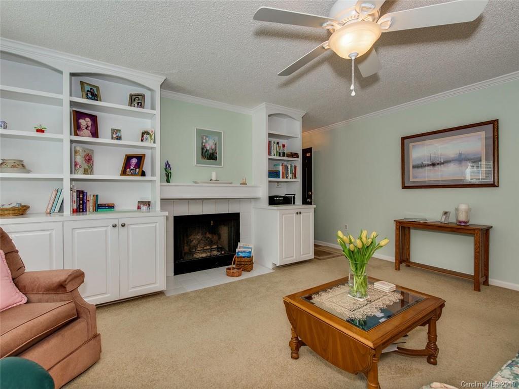 5009 Sharon Road Charlotte, NC 28210 - Photo 6 of 16 a living room with furniture and a fireplace
