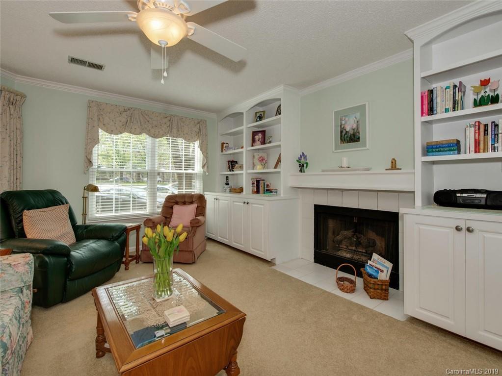 5009 Sharon Road Charlotte, NC 28210 - Photo 7 of 16 a living room with furniture and a fireplace