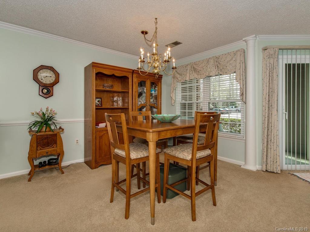 5009 Sharon Road Charlotte, NC 28210 - Photo 8 of 16 a view of a dining room with furniture and a chandelier