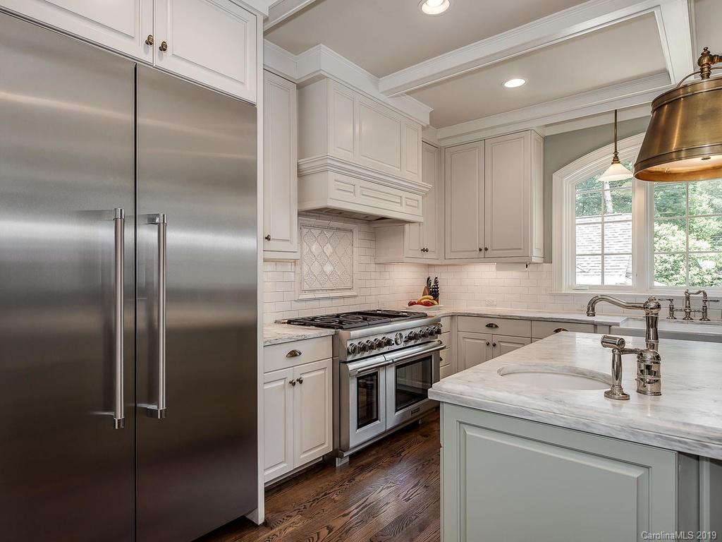1114 Andover Road Charlotte, NC 28211 - Photo 11 of 44 a kitchen with a stove a sink and a refrigerator
