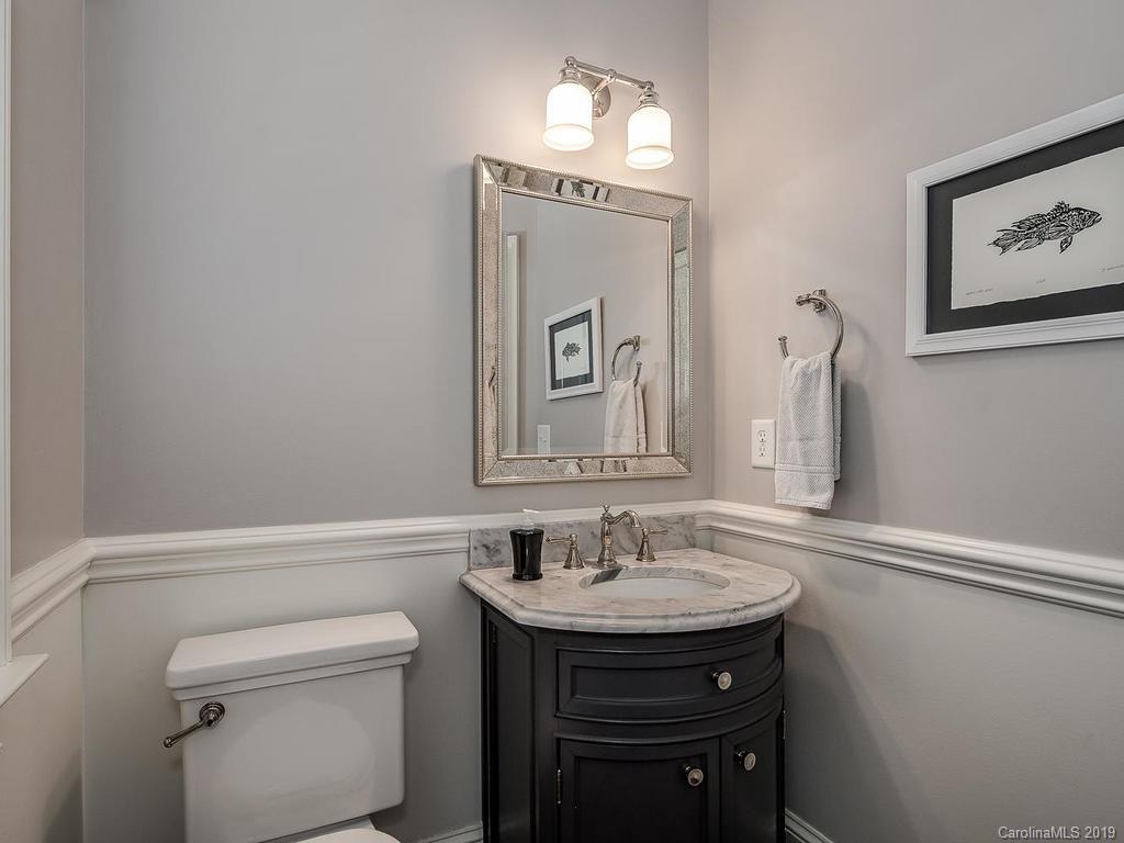 1114 Andover Road Charlotte, NC 28211 - Photo 18 of 44 a bathroom with a sink a mirror and a toilet