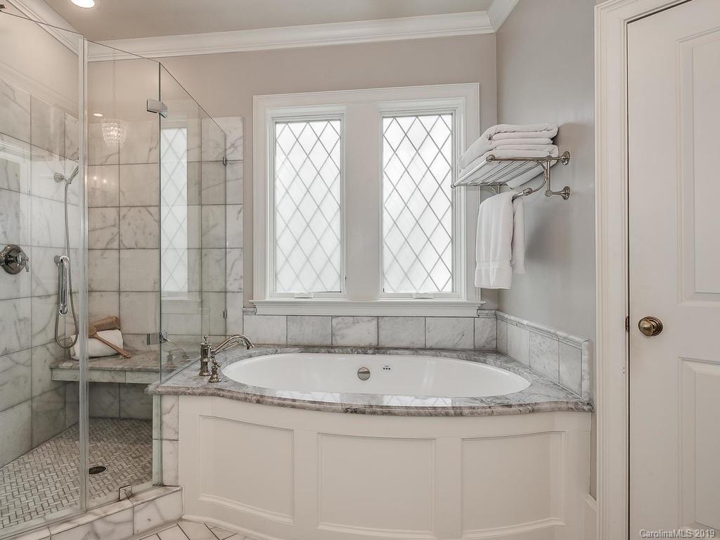 1114 Andover Road Charlotte, NC 28211 - Photo 23 of 44 a bathroom with a granite countertop sink a mirror and a bathtub