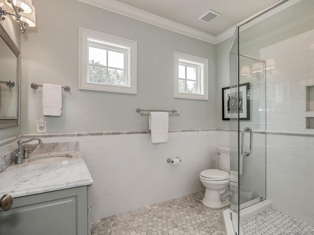 1114 Andover Road Charlotte, NC 28211 - Photo 31 of 44 a bathroom with a granite countertop sink a toilet and mirror