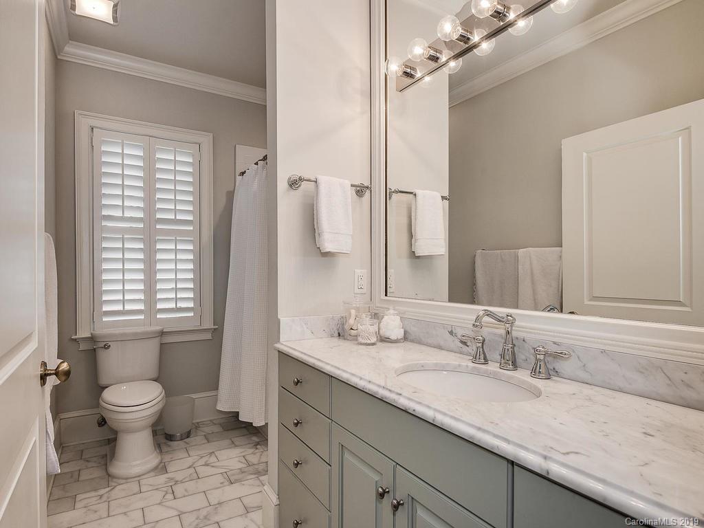 1114 Andover Road Charlotte, NC 28211 - Photo 33 of 44 a bathroom with a granite countertop sink a toilet and a large mirror