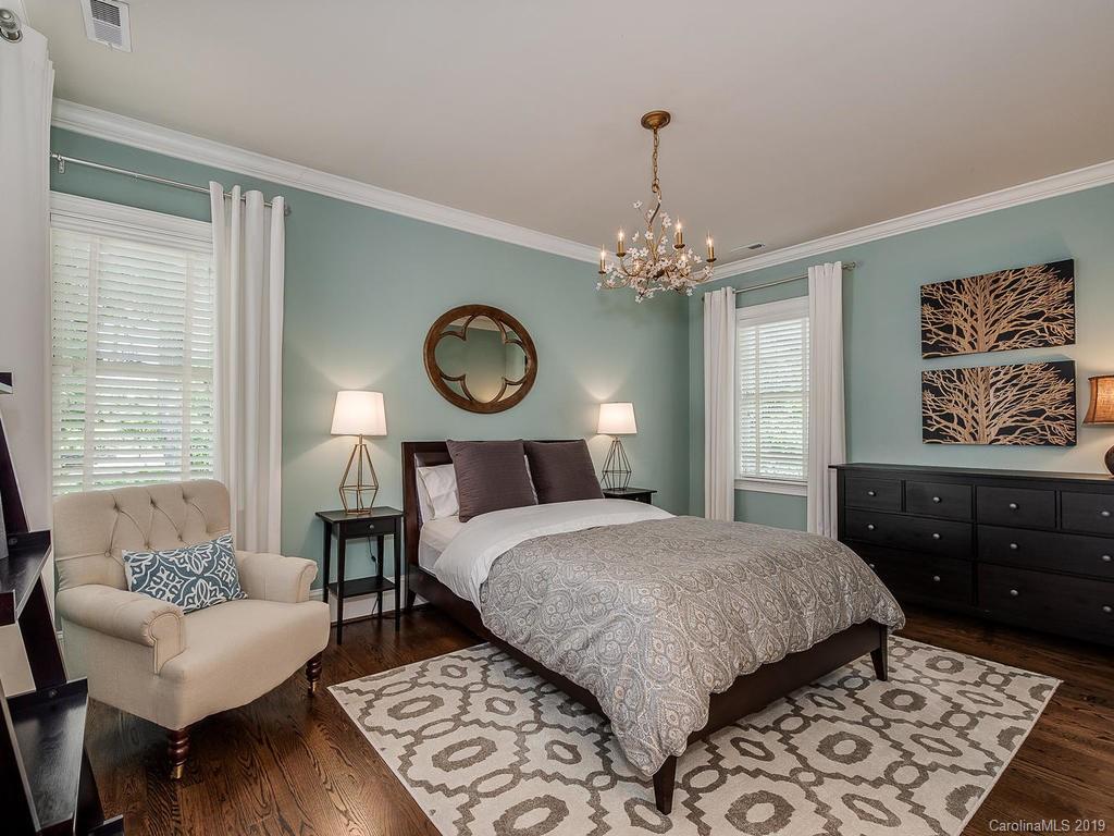 1114 Andover Road Charlotte, NC 28211 - Photo 34 of 44 a bedroom with a bed and wooden floor