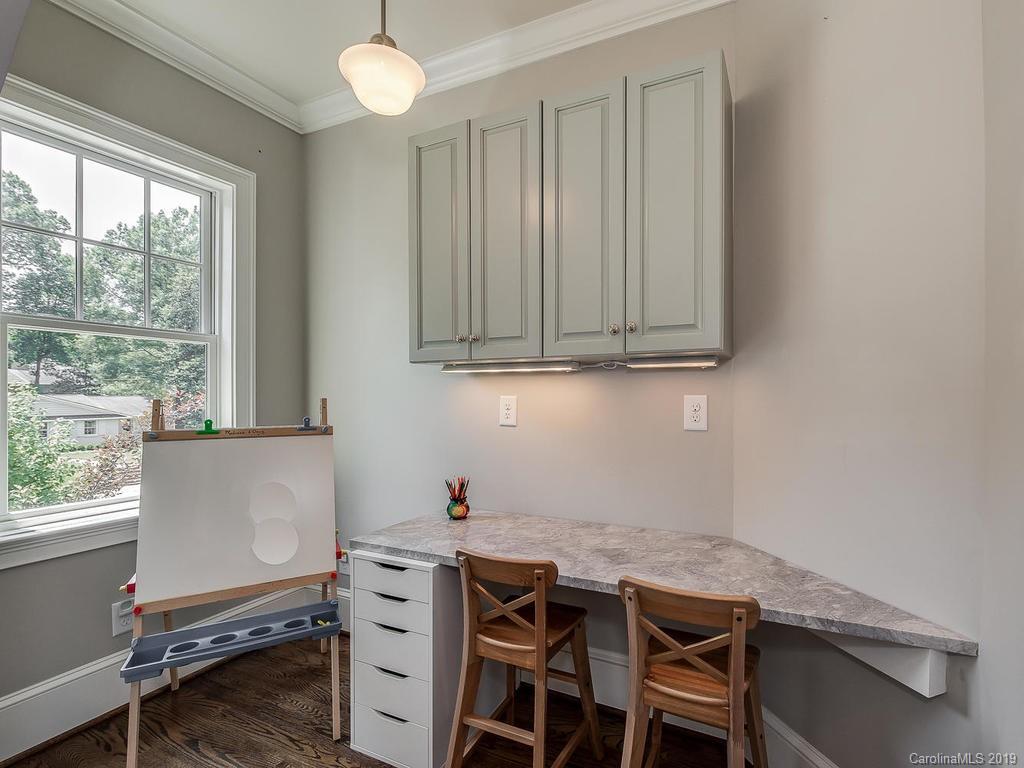 1114 Andover Road Charlotte, NC 28211 - Photo 37 of 44 a room with a window wooden cabinets and dining table