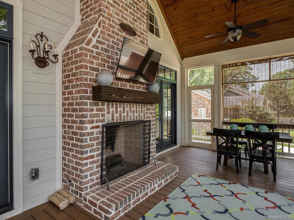 1114 Andover Road Charlotte, NC 28211 - Photo 38 of 44 a dining room with furniture a fireplace and large windows
