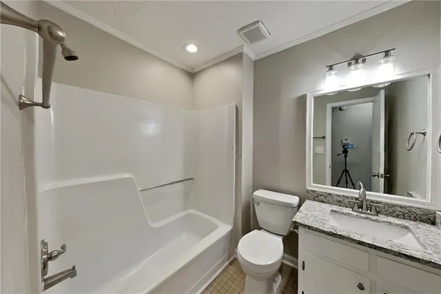 a bathroom with a granite countertop toilet sink and bathtub