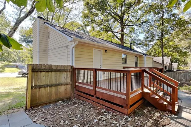a view of a house with a wooden deck