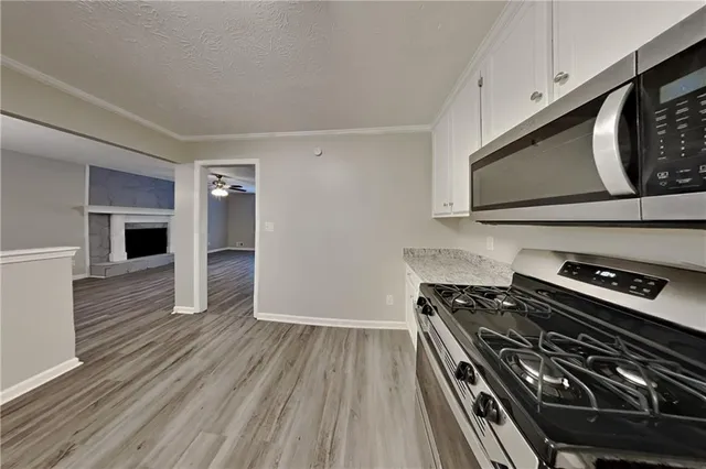 a kitchen with wooden floors and a stove