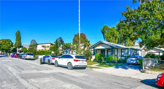 a car parked in front of a house with wooden fence