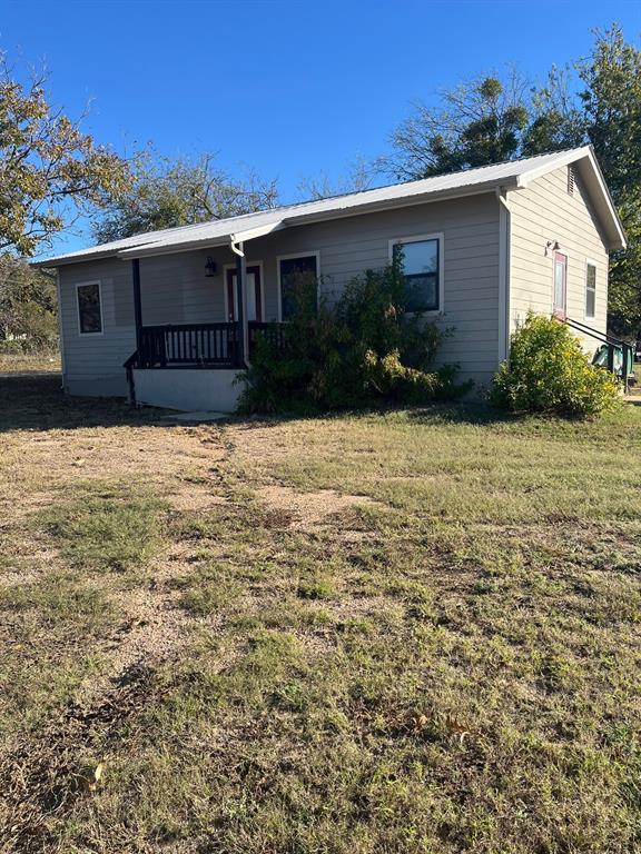 1310 Mesquite Street Goldthwaite, TX 76844 - Photo 1 of 8 a front view of a house with garden