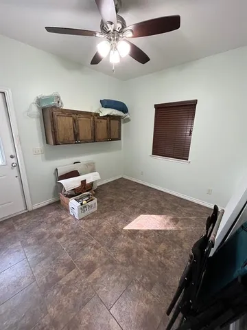 a workspace with furniture and ceiling fan