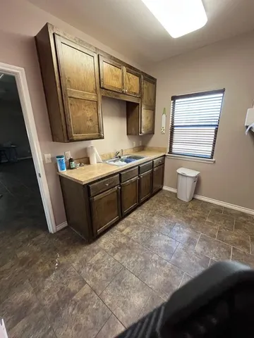 a room with a sink toilet and mirror