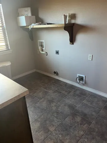 a view of a storage & utility room with a window