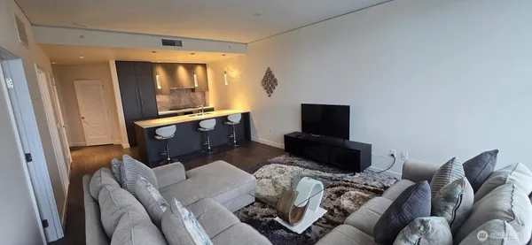 a living room with furniture and a large window