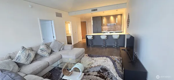 a view of living room with furniture and large windows