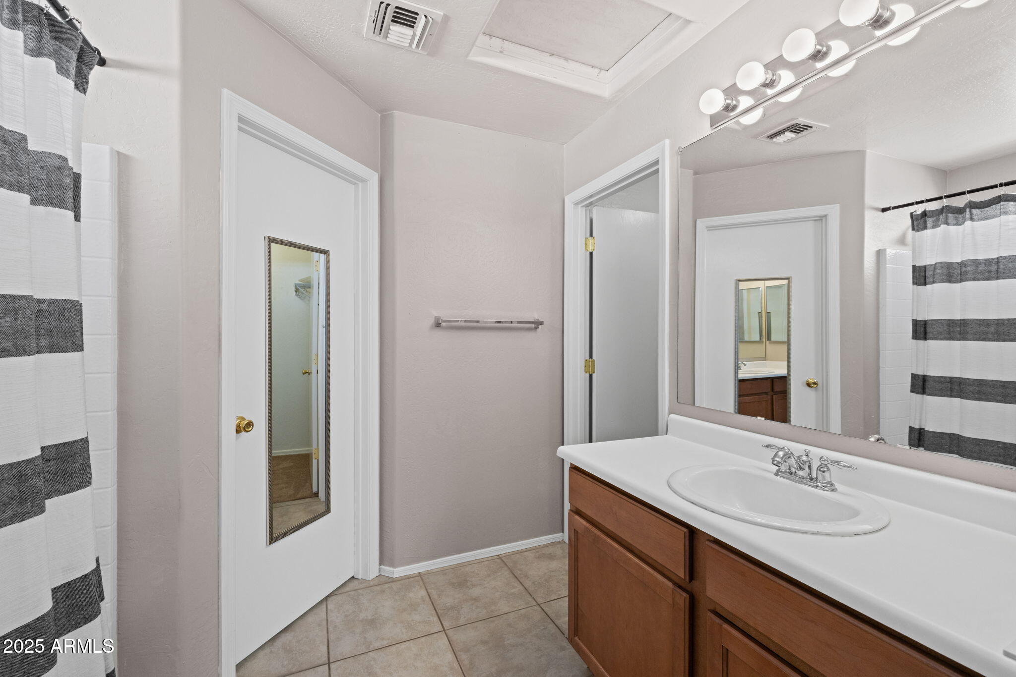 5312 Fulton Street Phoenix, AZ 85043 - Photo 17 of 26 a bathroom with a sink vanity and a mirror