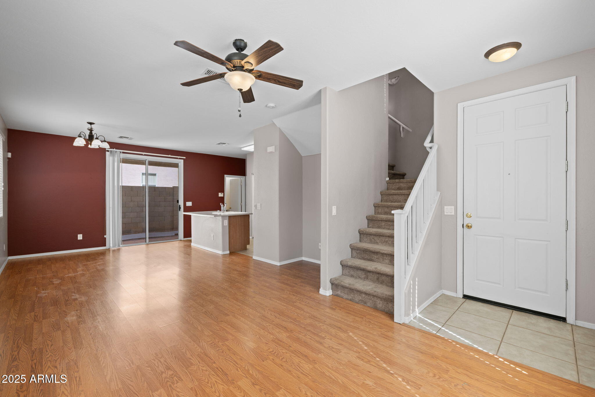 5312 Fulton Street Phoenix, AZ 85043 - Photo 3 of 26 a view of an empty room with wooden floor and a ceiling fan