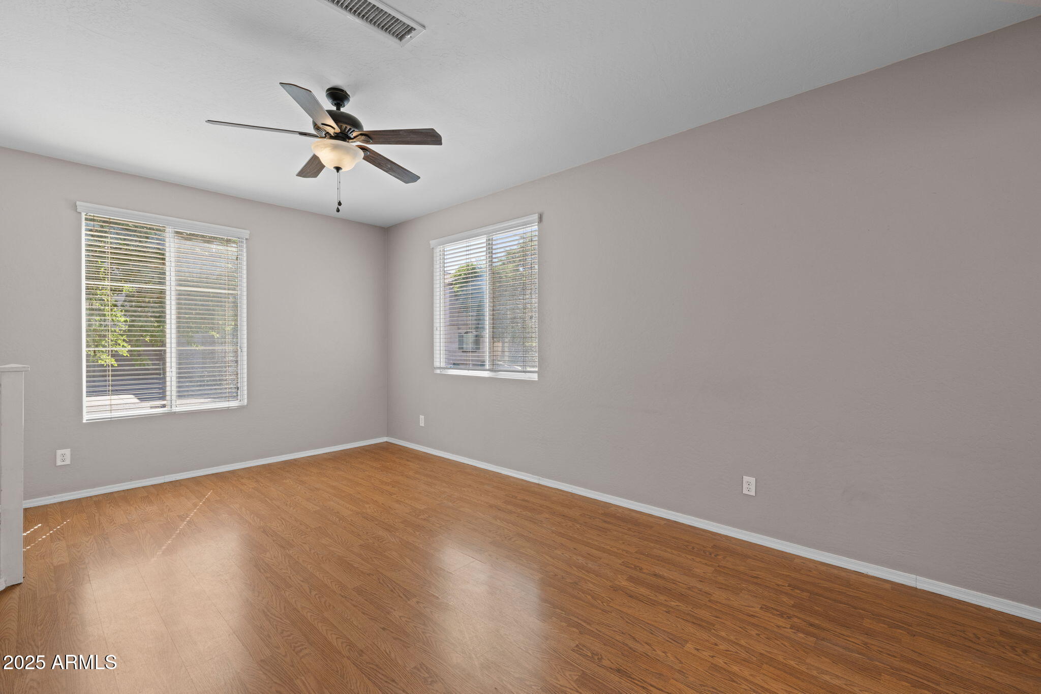 5312 Fulton Street Phoenix, AZ 85043 - Photo 6 of 26 a view of empty room with wooden floor and fan