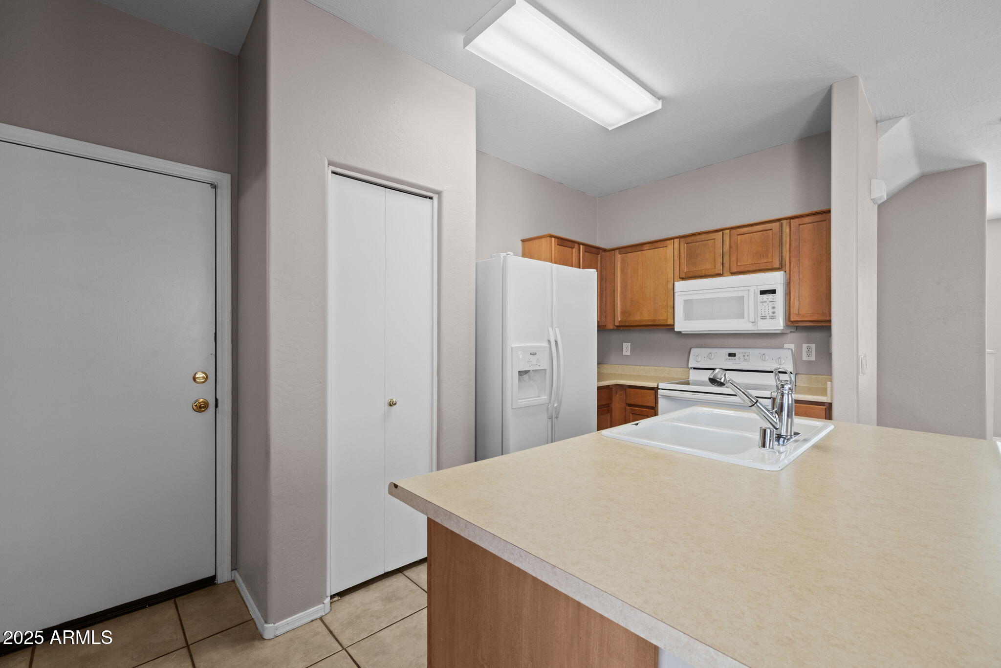 5312 Fulton Street Phoenix, AZ 85043 - Photo 8 of 26 a room with a refrigerator and a sink