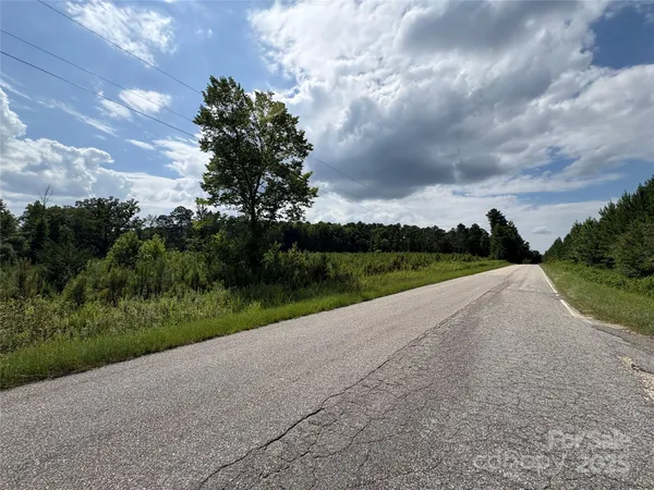 a view of a street with a yard