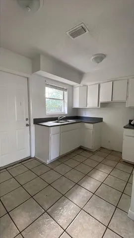 a kitchen with stainless steel appliances granite countertop a sink and cabinets
