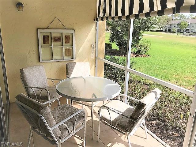 a balcony with table and chairs