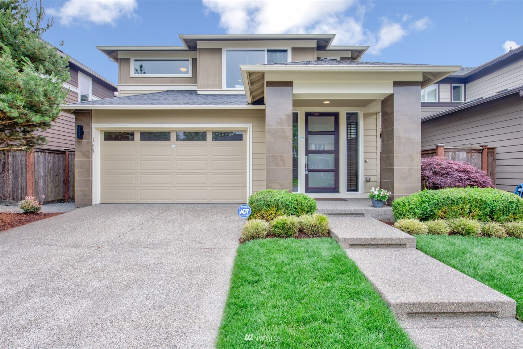 17007 40th Avenue Southeast Bothell, WA 98012 - Photo 1 of 26 a front view of a house with a yard and garage