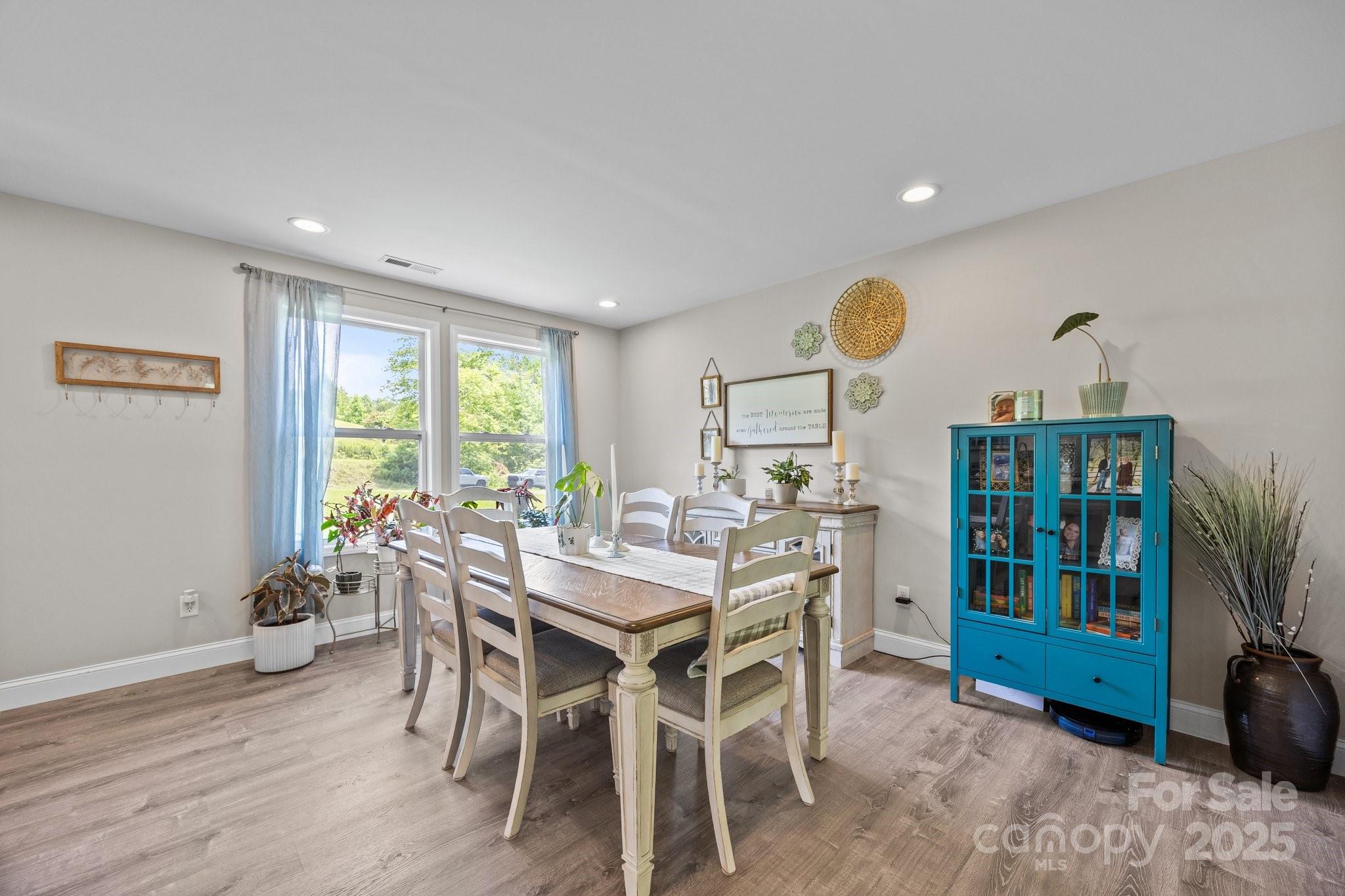 458 Summer Road Hendersonville, NC 28792 - Photo 14 of 29 a view of a dining room with furniture and a potted plant