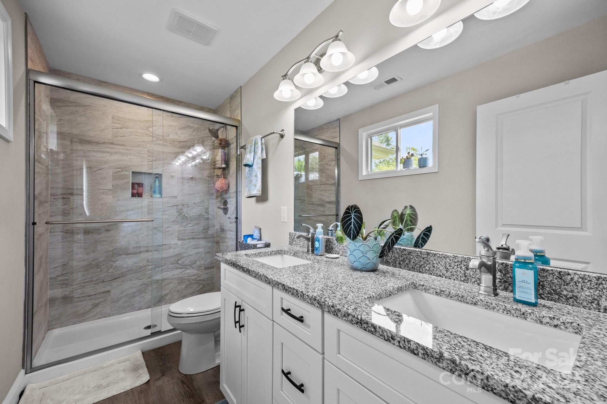 458 Summer Road Hendersonville, NC 28792 - Photo 16 of 29 a bathroom with a double vanity sink toilet and shower