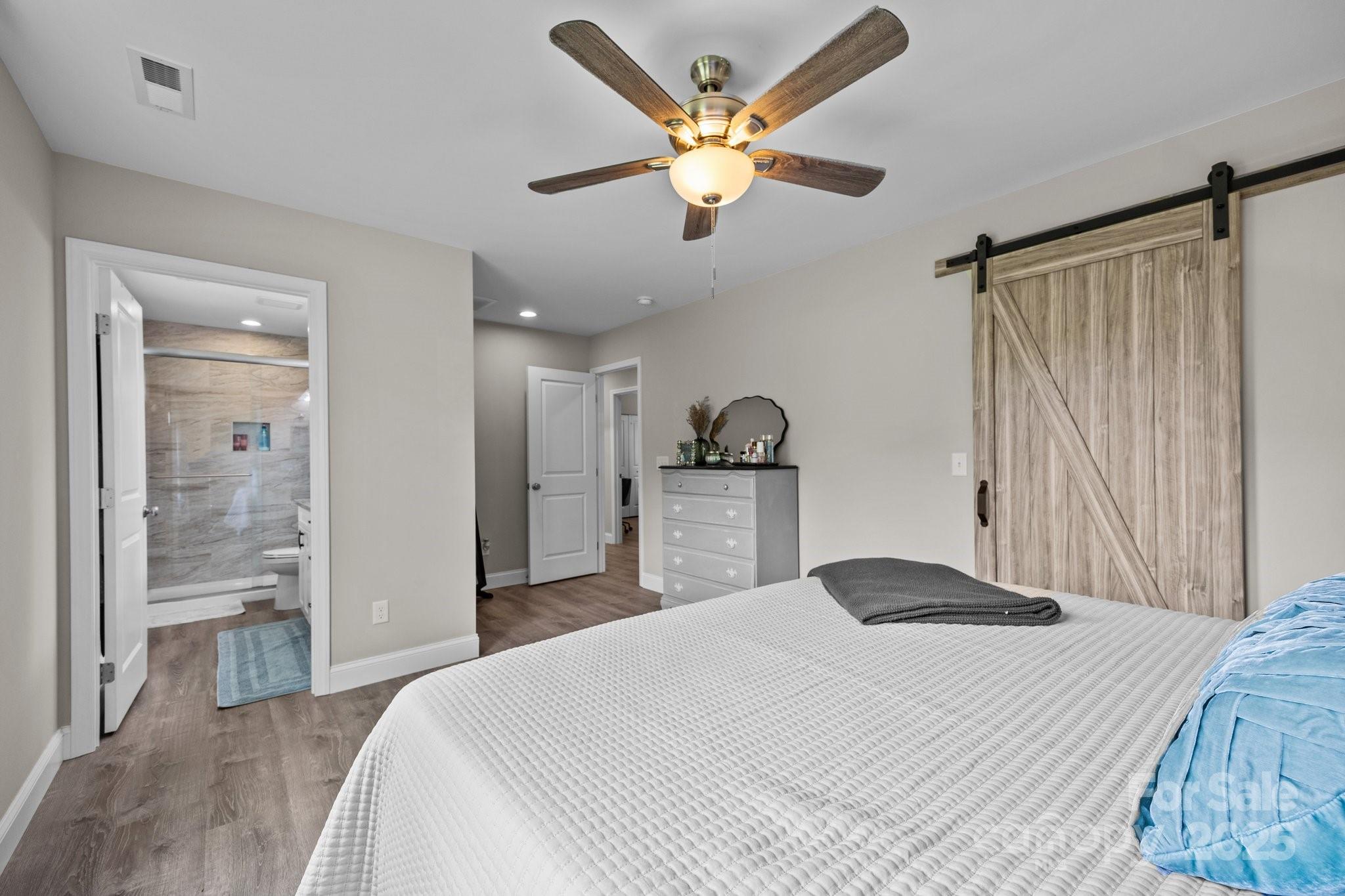 458 Summer Road Hendersonville, NC 28792 - Photo 18 of 29 a bedroom with a bed and a chandelier