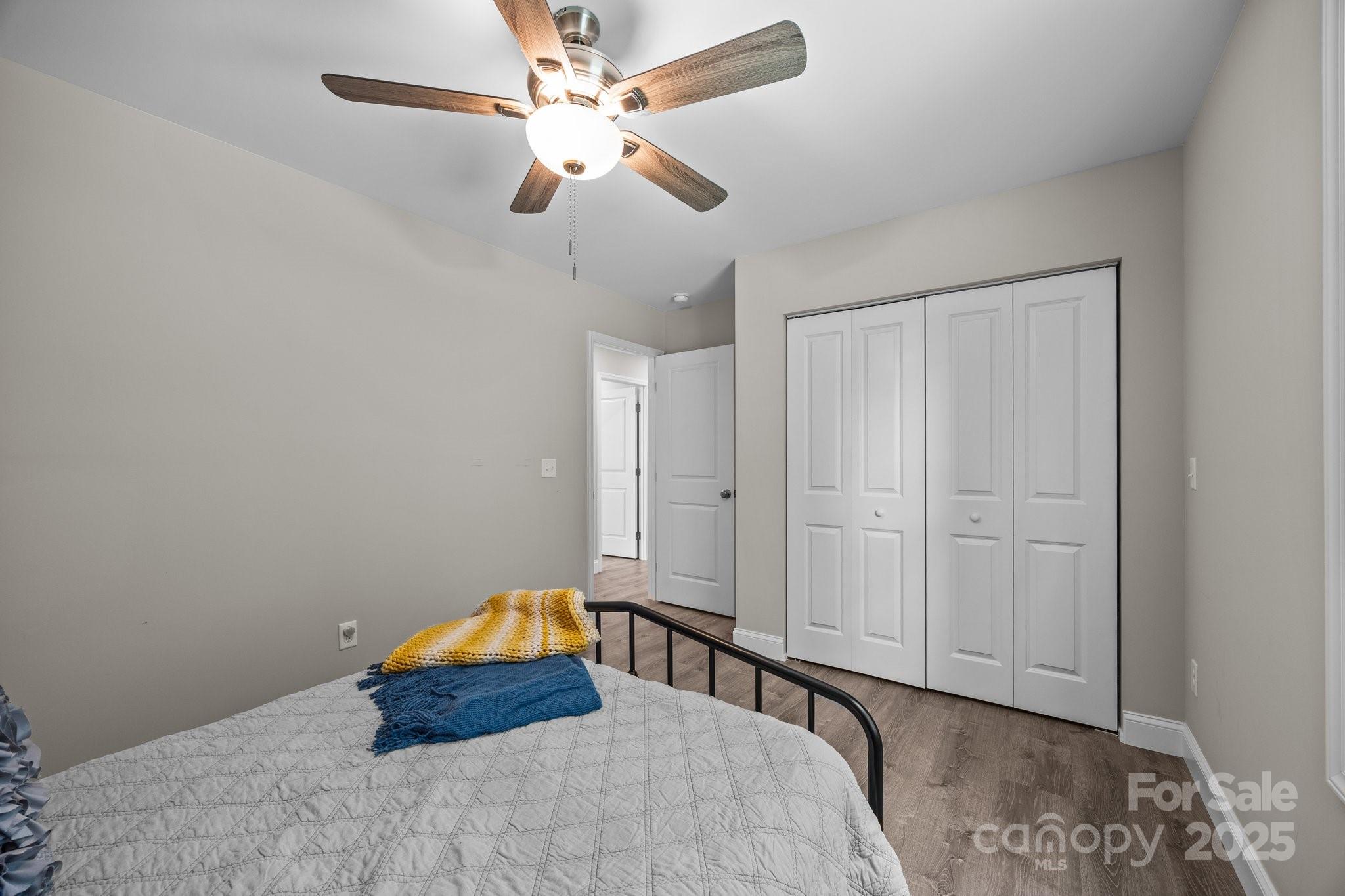 458 Summer Road Hendersonville, NC 28792 - Photo 21 of 29 a bedroom with a bed and a chandelier