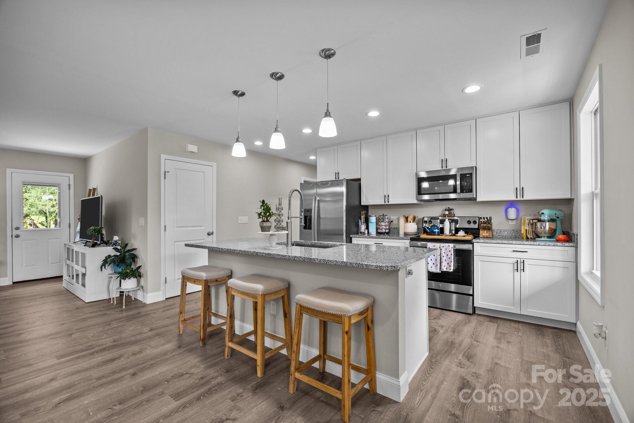 458 Summer Road Hendersonville, NC 28792 - Photo 5 of 29 a kitchen with white cabinets and counter space