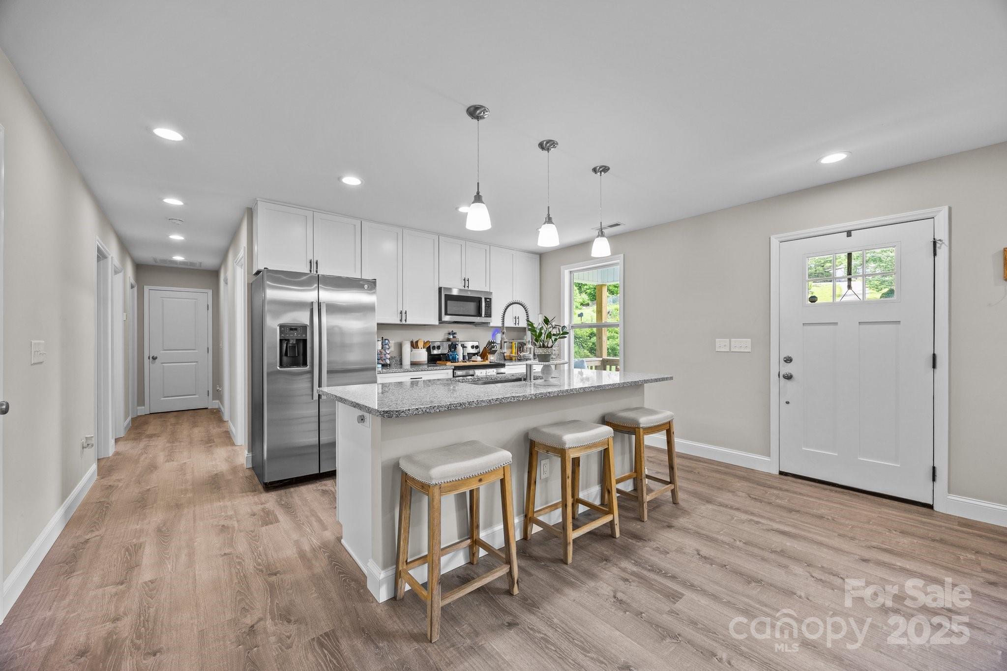 458 Summer Road Hendersonville, NC 28792 - Photo 7 of 29 a kitchen with stainless steel appliances granite countertop a refrigerator and a stove top oven