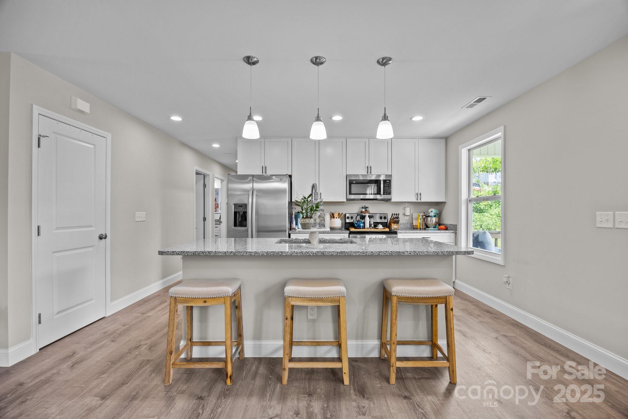 458 Summer Road Hendersonville, NC 28792 - Photo 8 of 29 a kitchen with refrigerator a sink and chairs