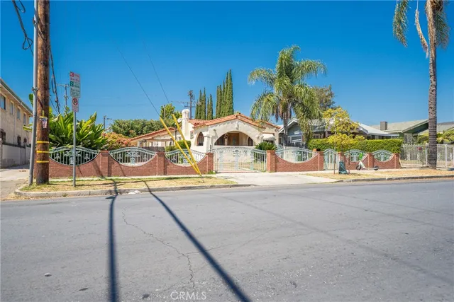 a view of a palm tree with dinning table and chairs in patio