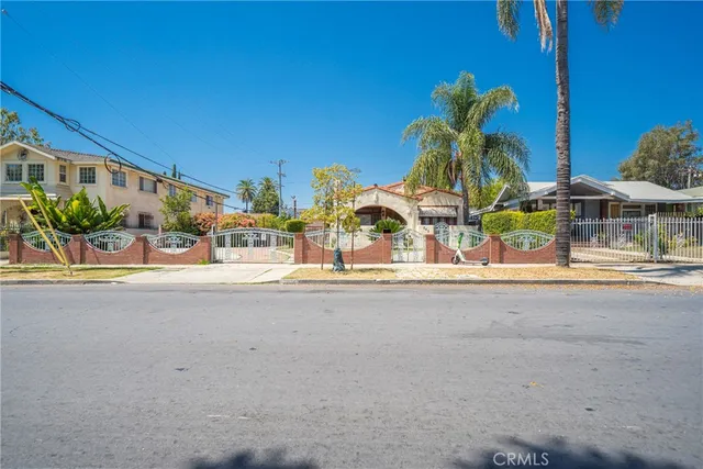 front view of a building with potted plants