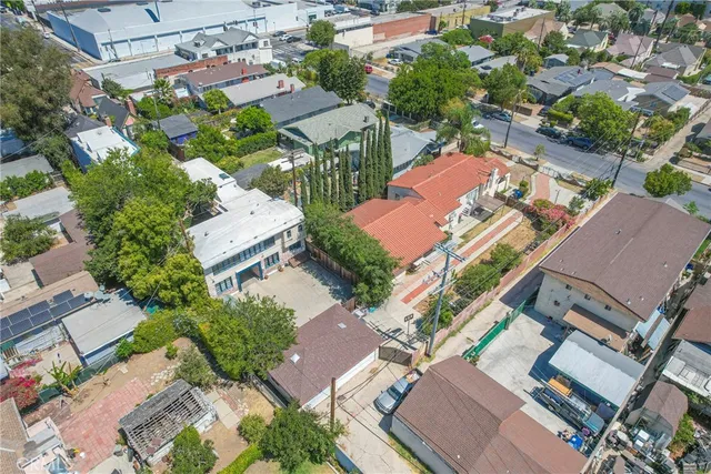 an aerial view of a houses with a street