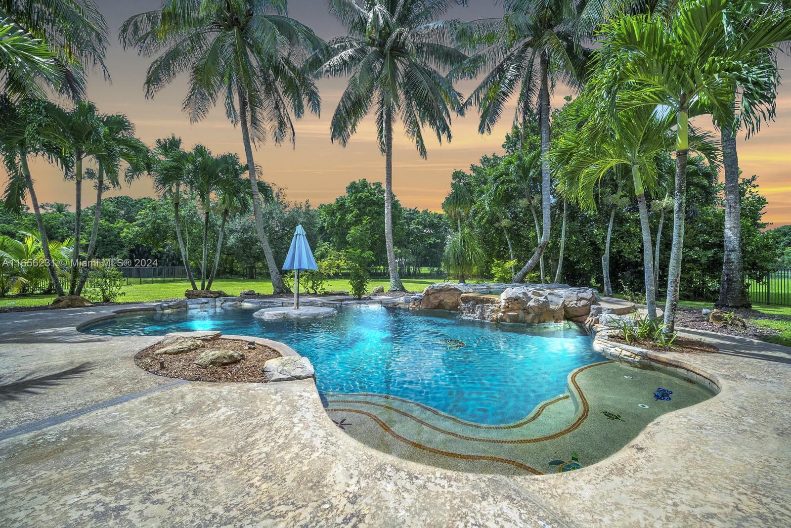 10278 Laurel Road Davie, FL 33328 - Photo 2 of 74 a view of a swimming pool with a sitting space