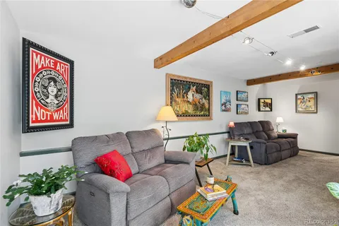 a kitchen with stainless steel appliances granite countertop dining table chairs refrigerator and sink