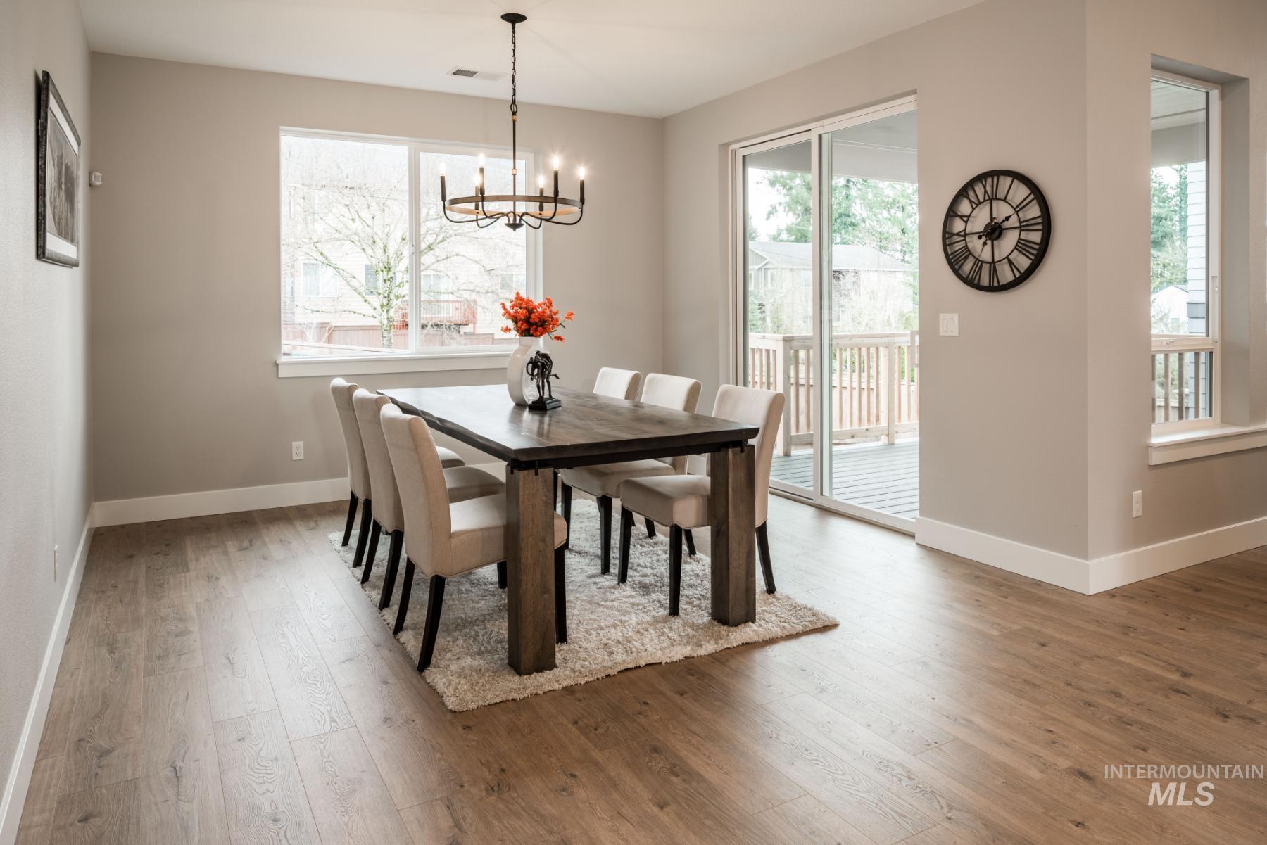 1279 West Malbar Street Meridian, ID 83646 - Photo 12 of 23 Dining room featuring hardwood / wood-style floors and a chandelier