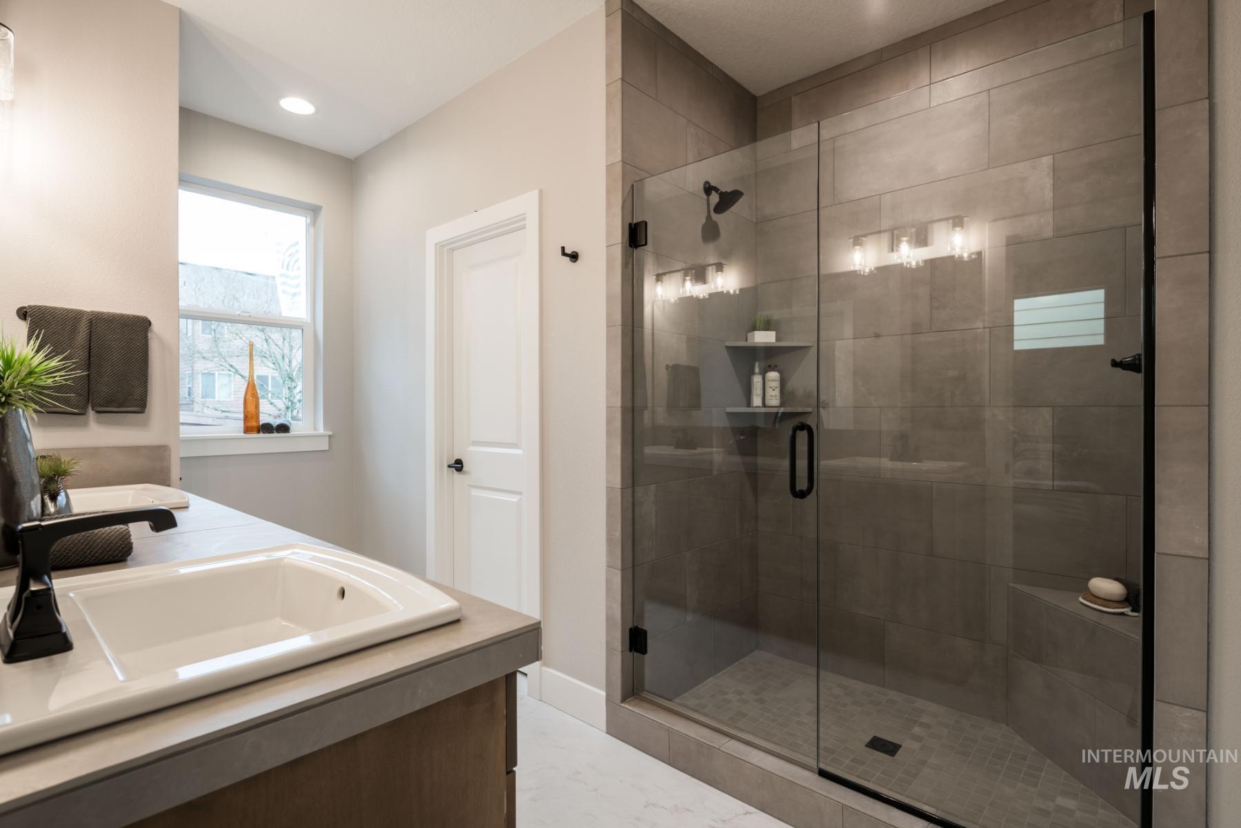 1279 West Malbar Street Meridian, ID 83646 - Photo 19 of 23 Bathroom featuring a shower stall, double vanity, recessed lighting, and marble finish floors